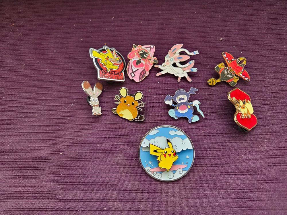Lot 601 – A collection of nine Pokemon themed enamel lapel pins