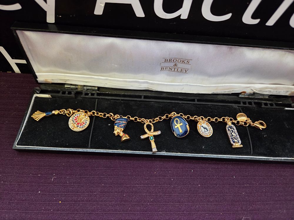 Lot 607 – A Brooks & Bentley Egyptian-themed gold-tone charm bracelet
