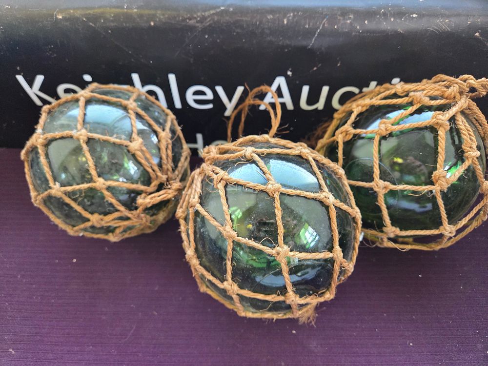 Lot 619 – A Trio of Vintage Green Glass Maritime Fishing Floats with Original Netting