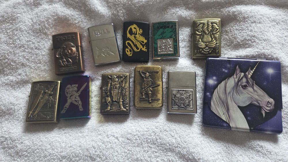 Lot 631 – A Collection of Decorative Flip-Top Pocket Lighters and a Graphic Motif Case
