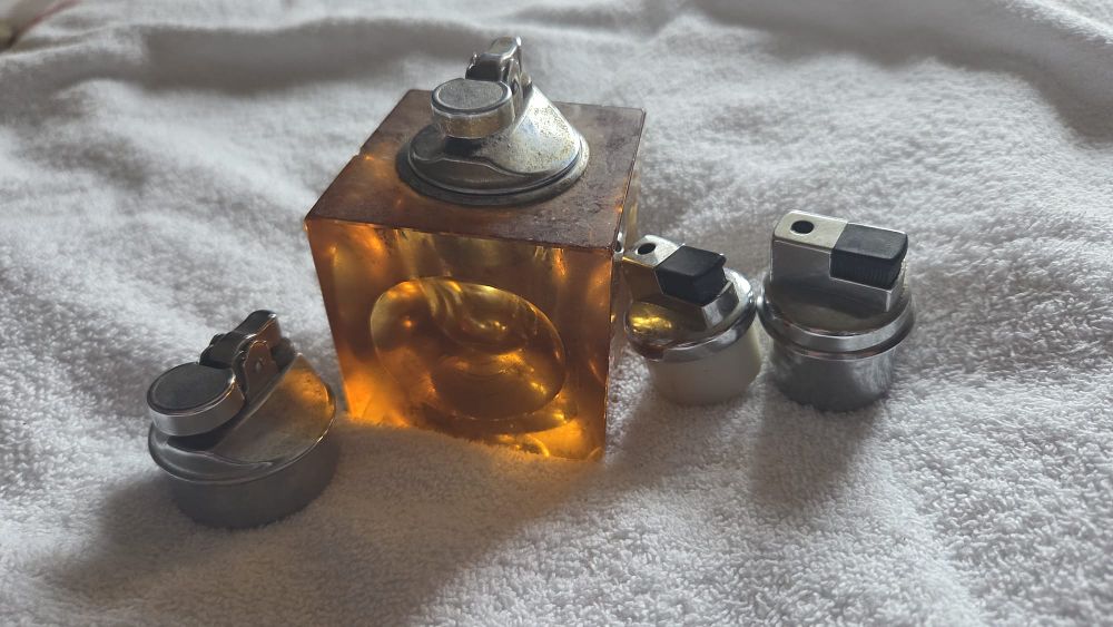 Lot 633 – A Collection of Japanese Mid-Century Modern Amber Resin Table Lighter Components