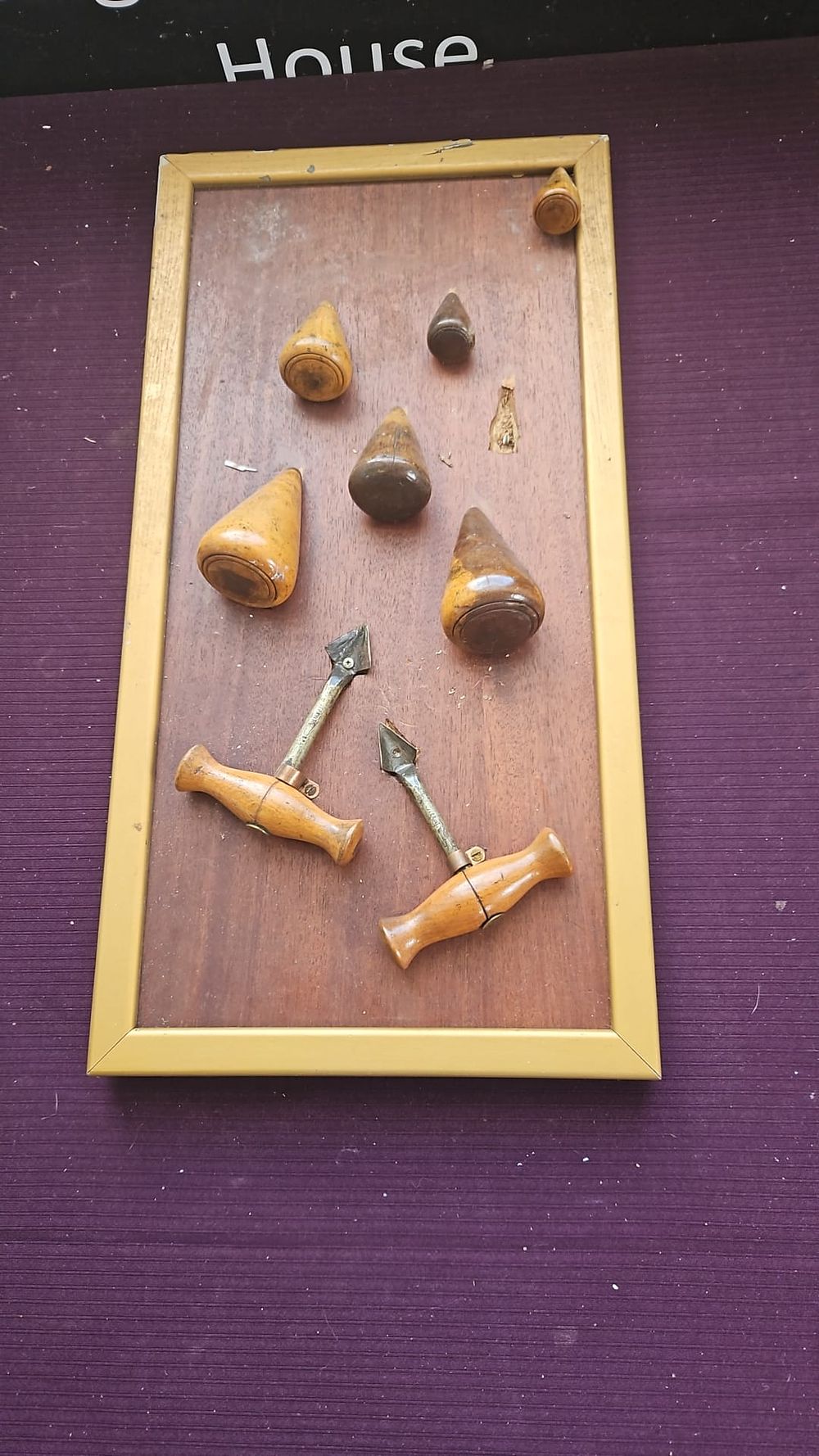 Lot 199 – A Collection of Vintage Cellarman’s Tools and Tapered Bungs Mounted in a Gilt Frame