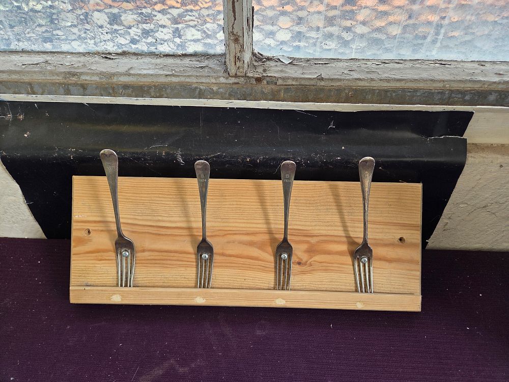 Lot 260 – A Rustic Wall-Mounted Coat Rack