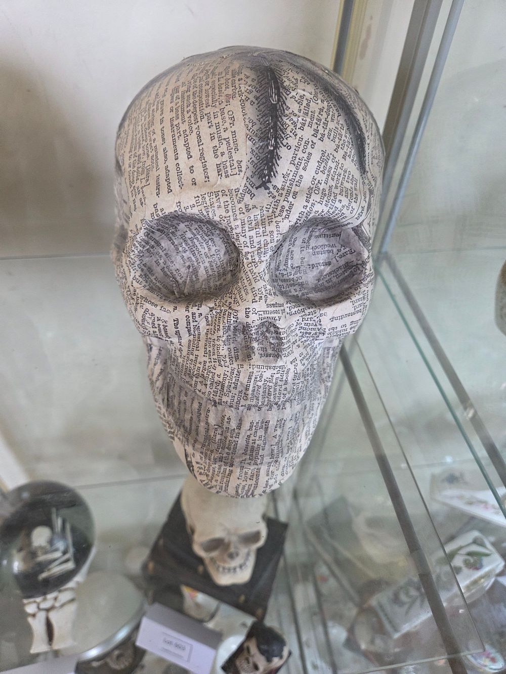 Lot 601 – A contemporary decoupaged resin decorative skull featuring a spider graphic