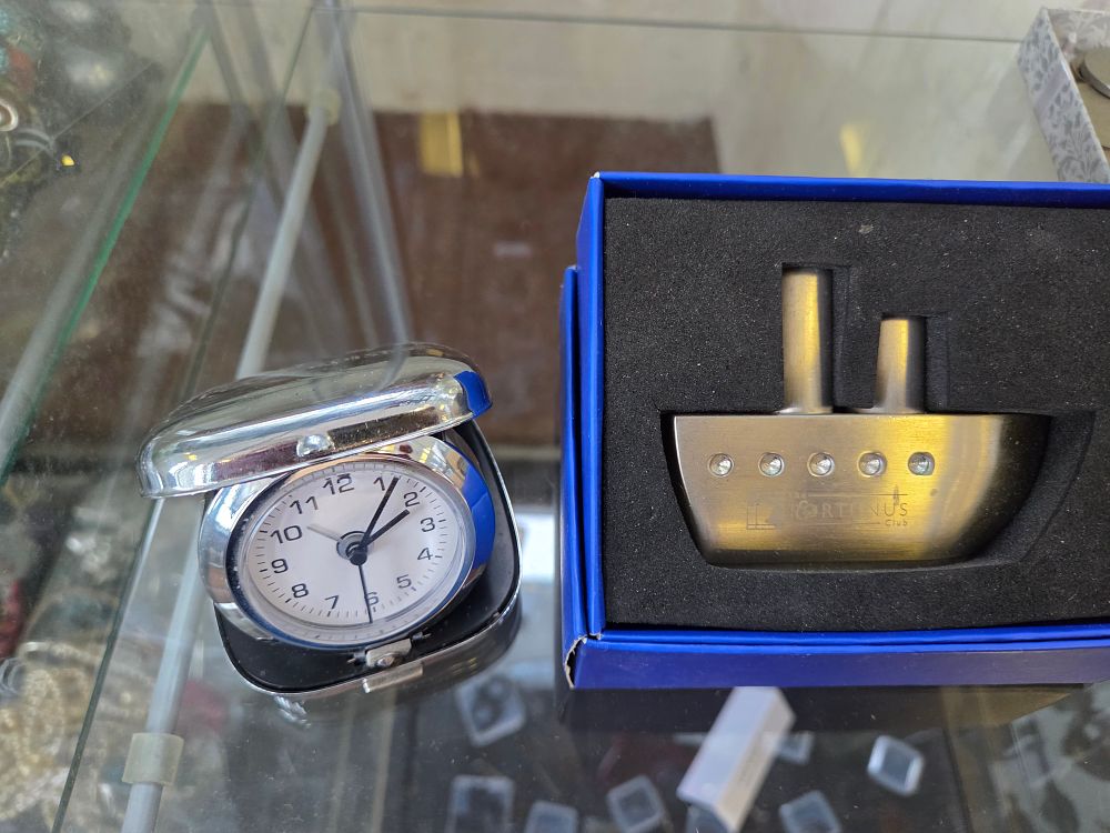 Lot 629 – Two P&O Cruises Promotional Items comprising a Travel Alarm Clock and a Portunus Club Desk Ornament