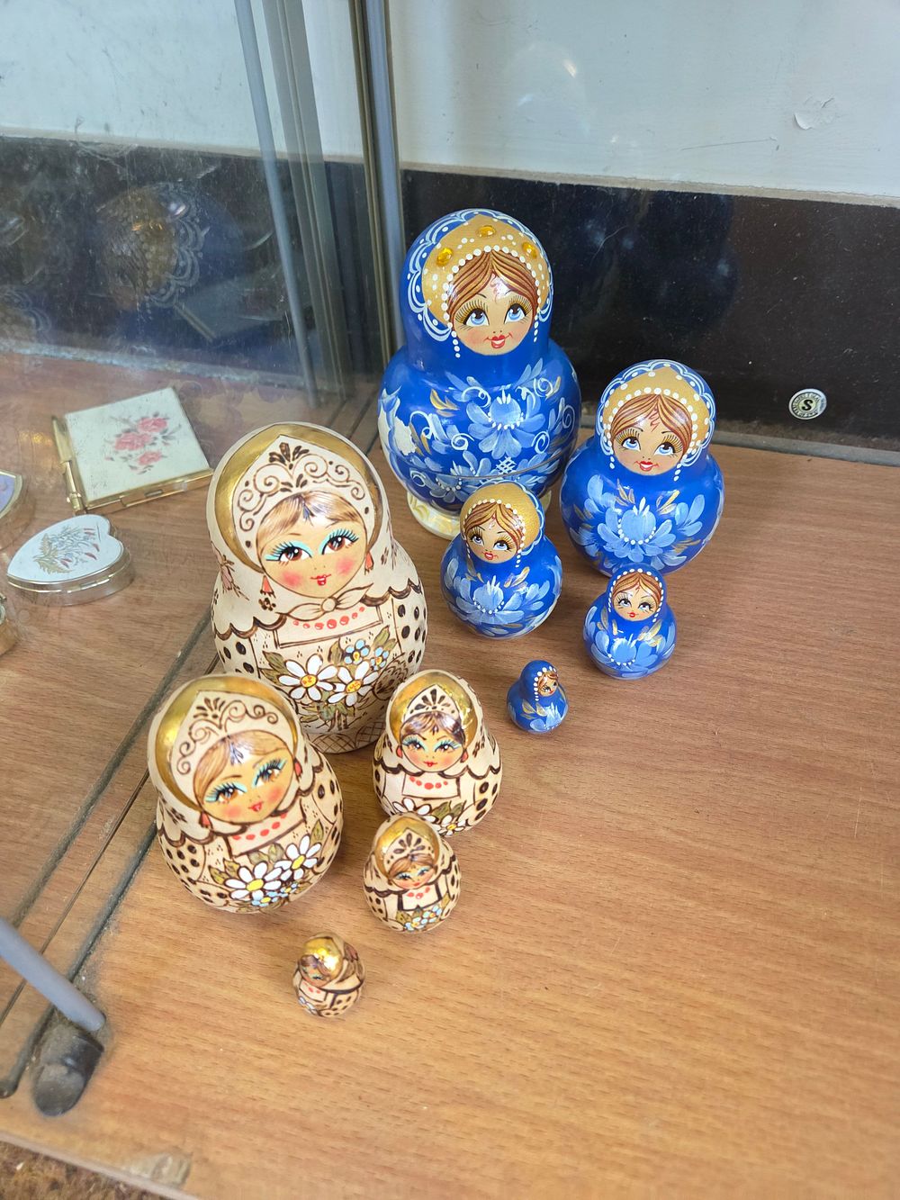 Lot 644 – A Group of Russian Floral and Gzhel Style Wooden Nesting Dolls