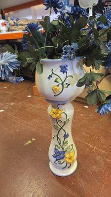A large majolica-style ceramic pedestal planter and base with relief decoration