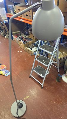 A contemporary adjustable metal floor lamp