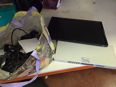 A Collection of Computer and Networking Equipment Including an ASUS Monitor and Dynamode Switch