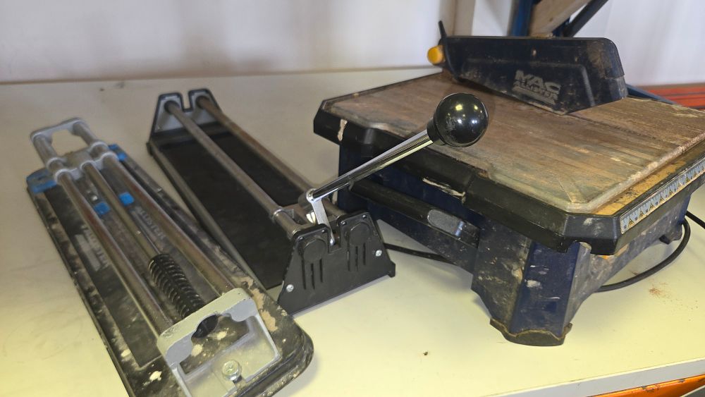 Lot 300 – Three Mac Allister Tile Cutting Tools Including a Manual Rail Cutter and an Electric Wet Saw w/o
