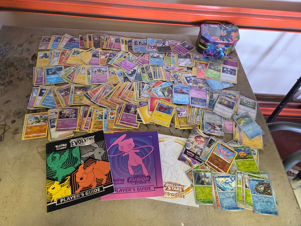 Lot 332 – Assortment of approximately 150-200 Pokémon Trading Cards with Elite Trainer Box Player’s Guides and Collector’s Tin