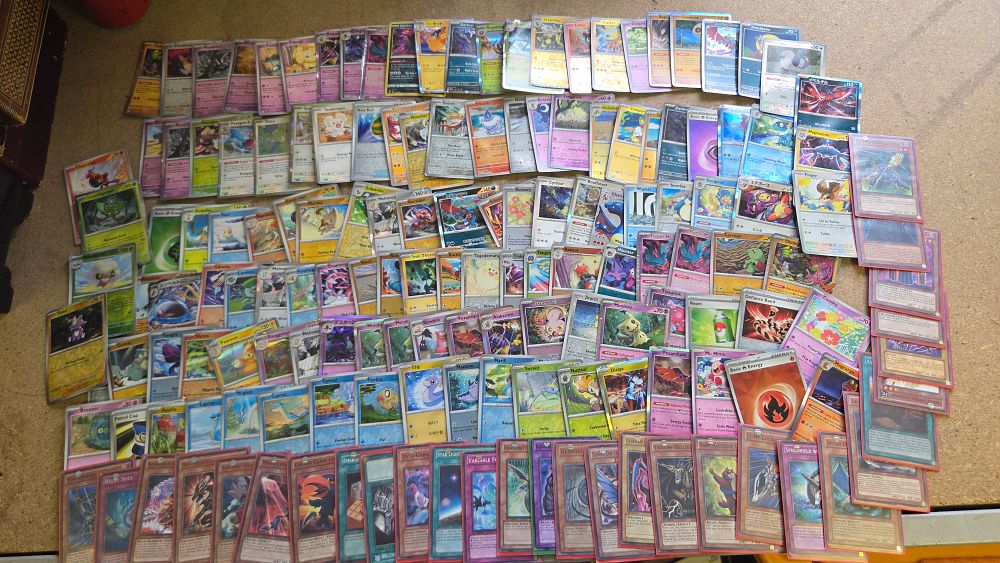 Lot 169 – An Assortment of Modern Pokémon and Yu-Gi-Oh! Trading Cards Including English and Japanese Editions