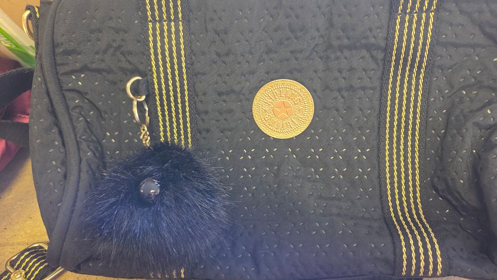 Lot 190 – A Kipling Black Quilted and Perforated Fabric Handbag with Keychain