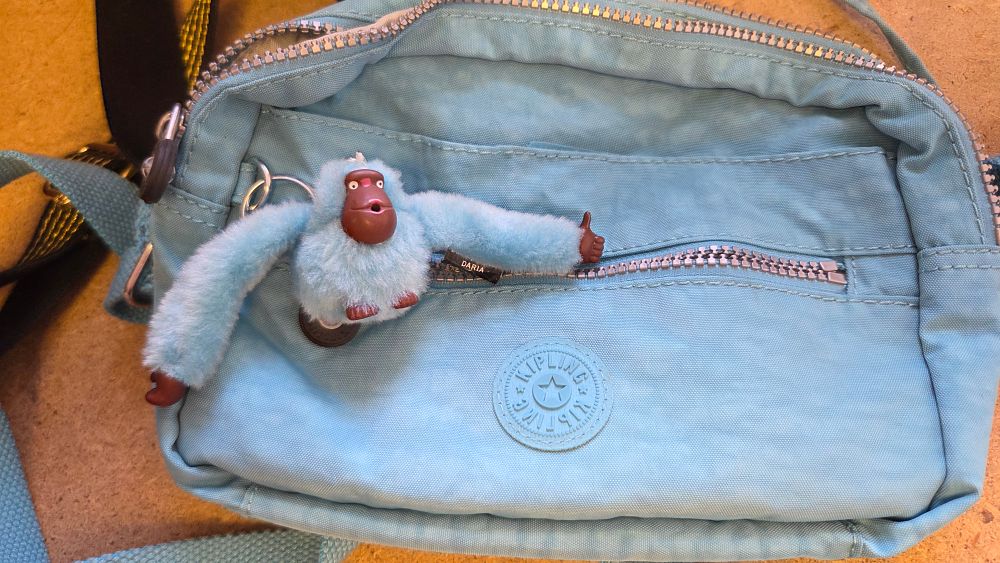 Lot 191 – A Kipling Light Blue Crinkled Nylon Multi-Compartment Crossbody Bag with Daria Monkey Keychain