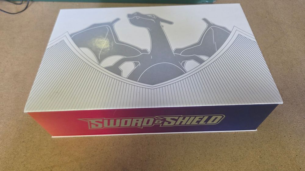 Lot 257 – A Collection of Pokémon TCG Cards and Sword and Shield Charizard Ultra-Premium Collection Storage Boxes