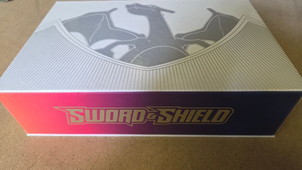 Lot 258 – A Collection of Pokémon TCG Cards and Sword and Shield Charizard Ultra-Premium Collection Storage Boxes