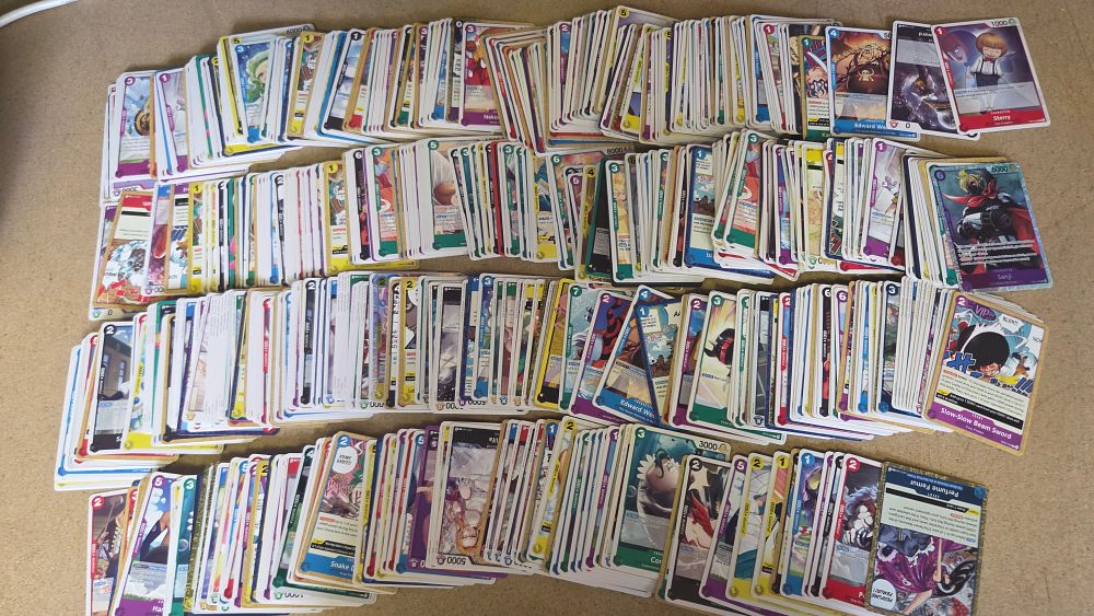 Lot 260 – An Assortment of One Piece Card Game Trading Cards Including Super Rare and Rare Variants