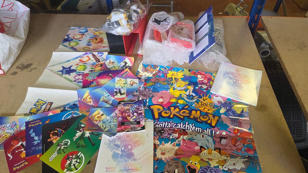 Lot 292 – A Collection of Pokémon Trading Card Game Promotional Materials and Accessories including Scarlet & Violet Prismatic Evolutions