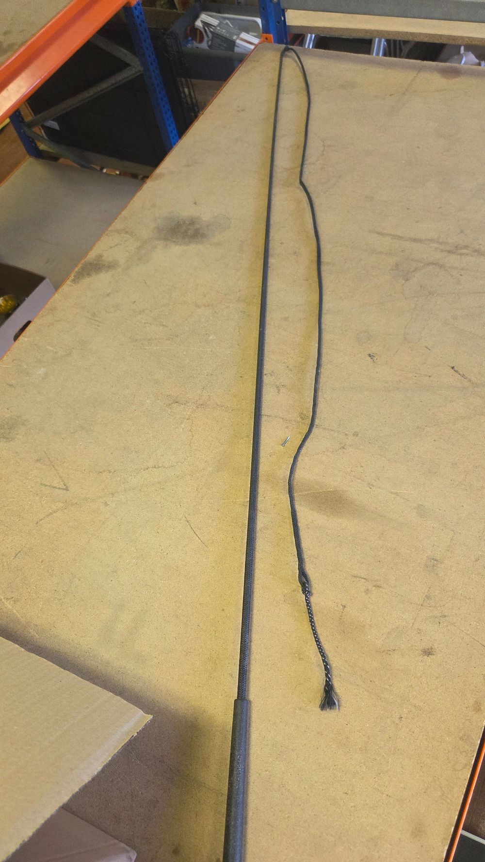 Lot 312 – A long black synthetic lunging whip
