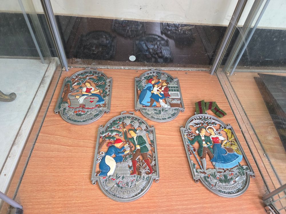 Lot 630 – A Set of Four Polychrome Painted Pewter Seasonal Wall Plaques