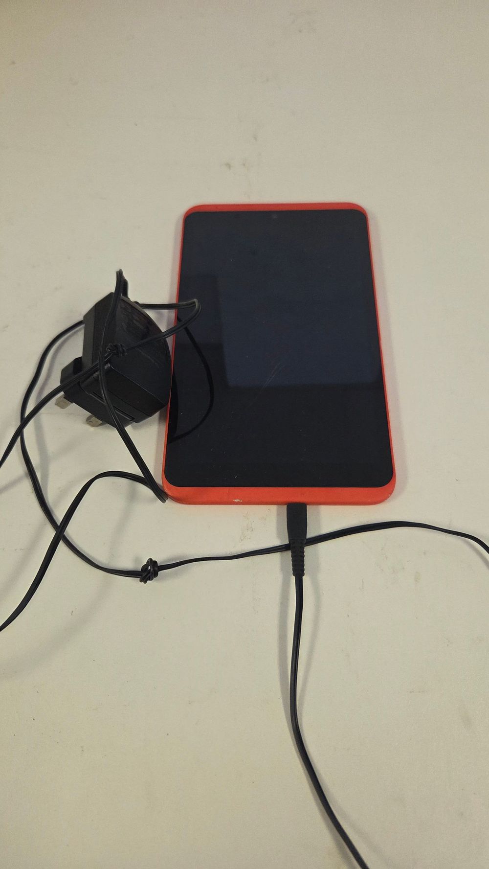 Lot 169 – Tesco Hudl 16GB Wi-Fi Tablet in Orange with UK Charger powers on
