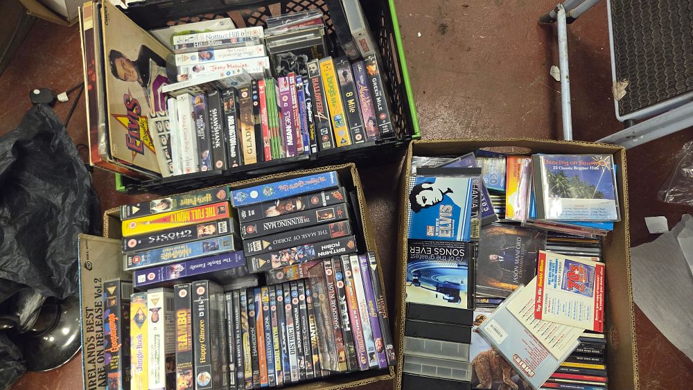 Lot 195 – Three Boxes of Mixed Entertainment Media Including DVDs, VHS Tapes, and CDs
