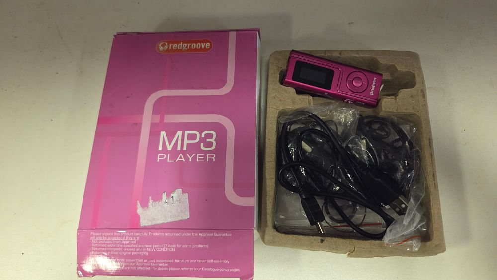 Lot 197 – A Redgroove Digital MP3 Player in Metallic Pink with Accessories and Original Packaging