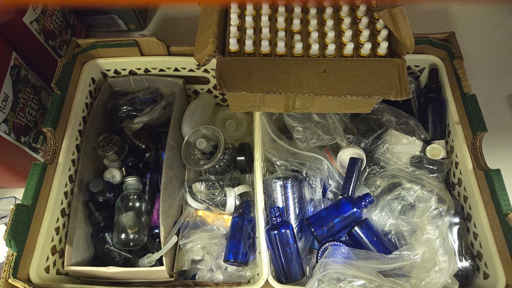 Lot 201 – A Large Collection of Cobalt Blue Clear and Amber Glass Cosmetic Bottles with Dropper and Spray Accessories
