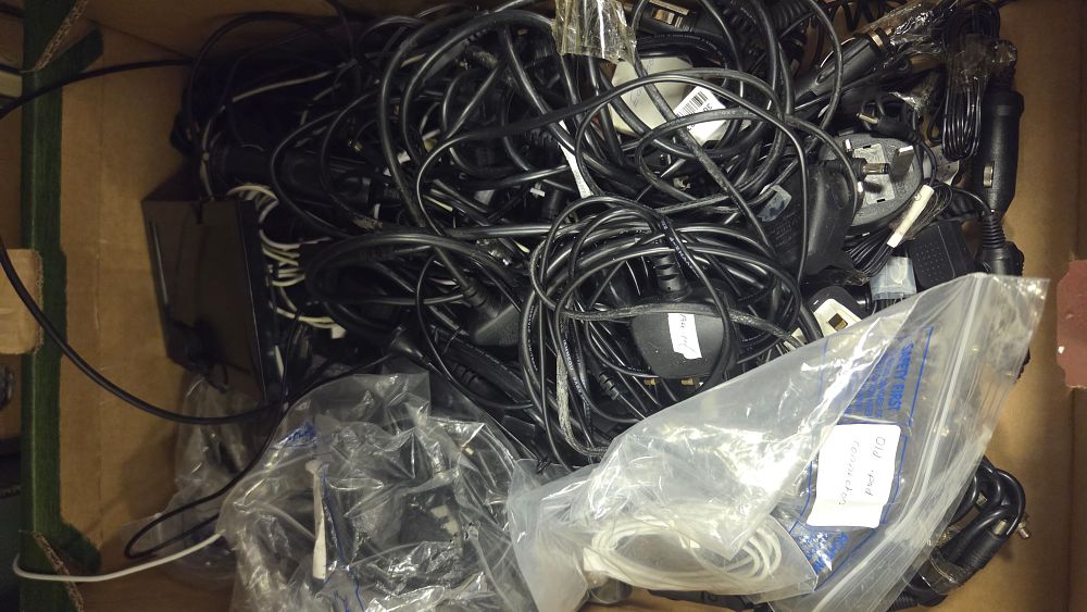 Lot 203 – An Assortment of Miscellaneous Electronic Cables, Power Adapters, and Peripherals