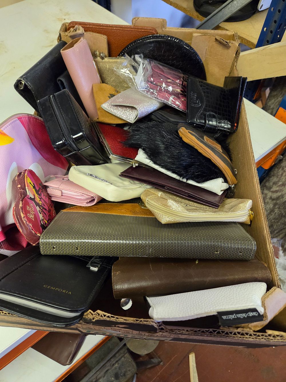 Lot 300 – An Assortment of Fashion Accessories Including Wallets, Purses, and Cosmetic Pouches