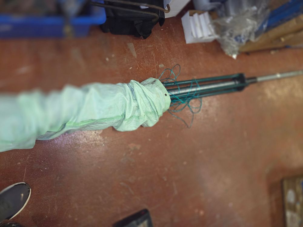 Lot 344 – A modern metal rotary clothes airer with a green synthetic cover