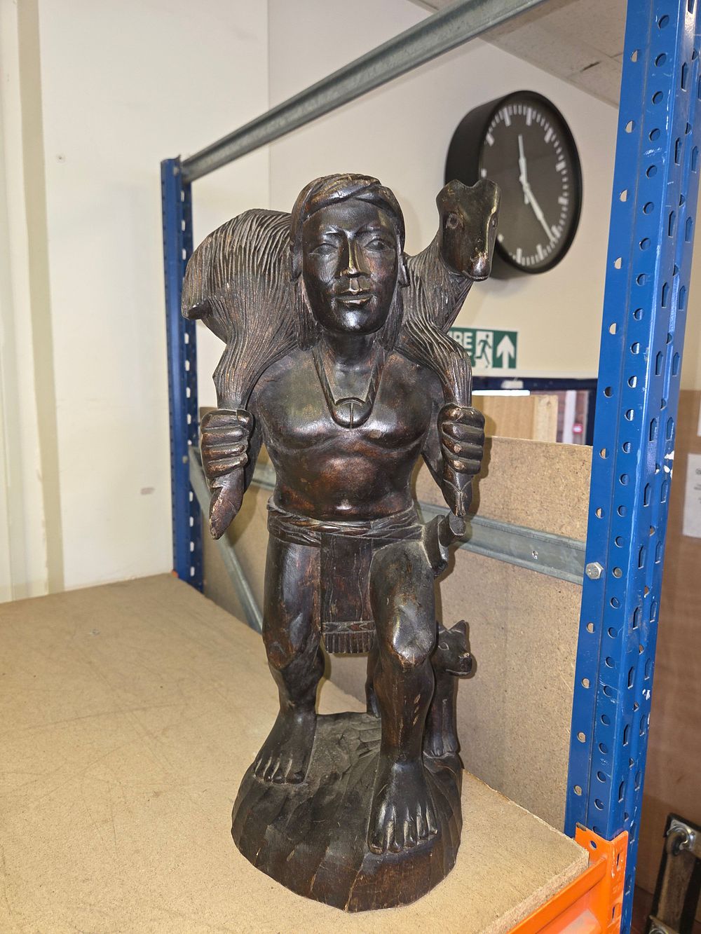 Lot 361 – A mid-20th century hand-carved dark wood sculpture of a hunter