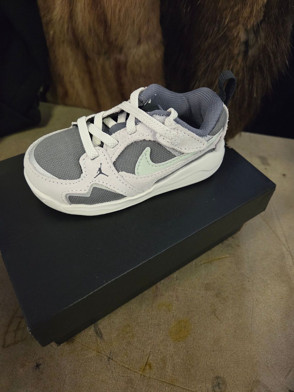 Lot 401 – A Pair of New Infant Jordan CMFT Era Low-Top Sneakers UK Size 5.5