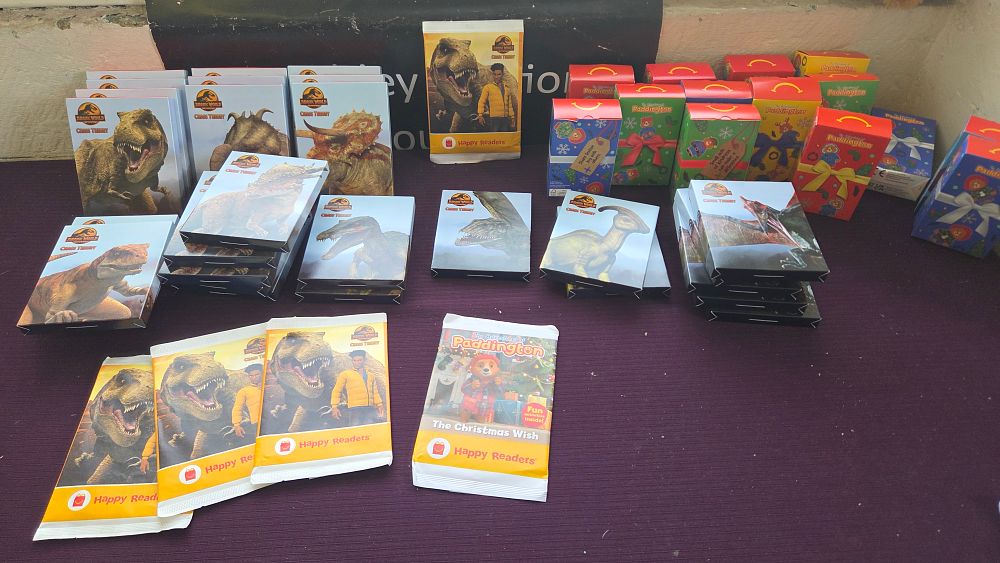Lot 167 – A Collection of McDonald’s Happy Meal Jurassic World, Paddington, Crayola and Asmodee Dobble Promotional Books, Activity Kits and Themed Card Games