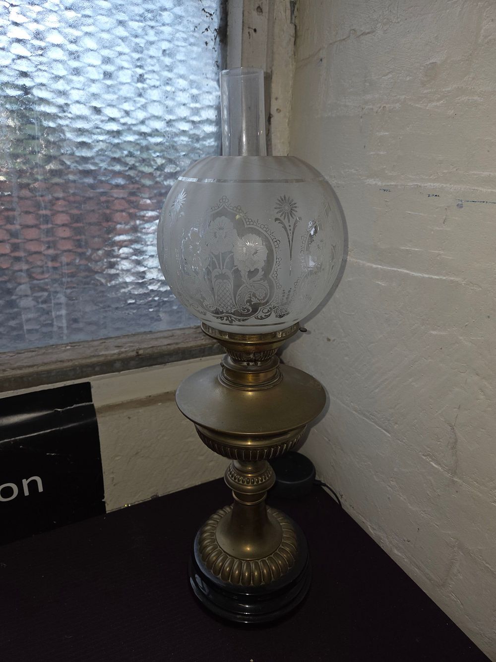 Lot 161 – A late Victorian brass pedestal oil lamp converted for electricity with etched glass globe shade