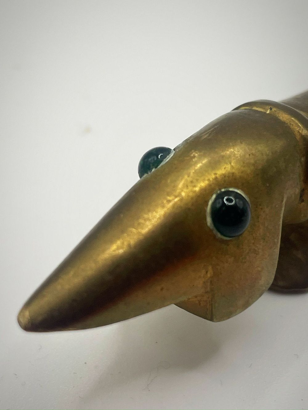 Lot 172 – A mid-century modern cast brass dachshund letter opener. Agenuine Walter Bosse due to the inset green eyes which are a definitive hallmark feature specific to Walter Bosse mid century design.  Herta Baller operated the prominent Viennese art foundry and w
