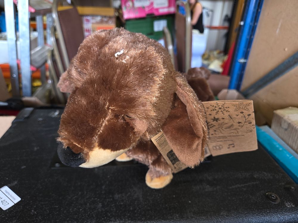 Lot 410 – An Animated Musical Plush Sausage Dog Character with Christmas Themed Tags