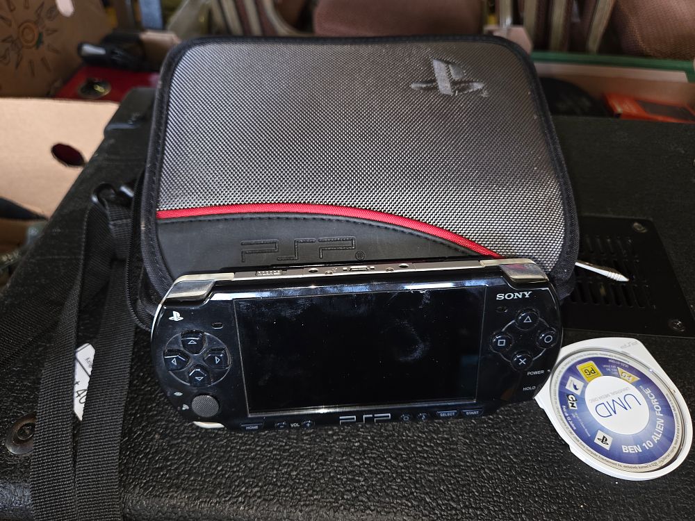 Lot 411 – Sony PlayStation Portable PSP Handheld Console with Branded Case and UMD Game