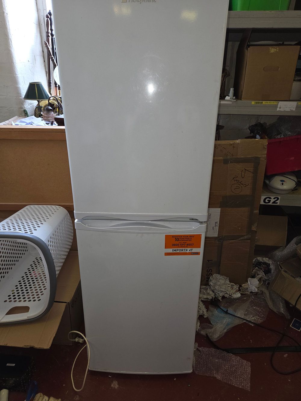 Lot 427 – A Hotpoint freestanding tall fridge-freezer in white w/o