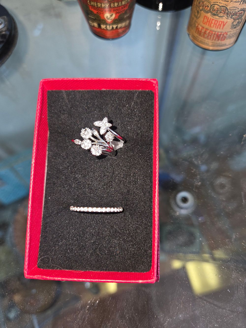 Lot 629 – Two Silver 925 and colourless stone rings comprising a floral spray wrap-around ring and a slim eternity band