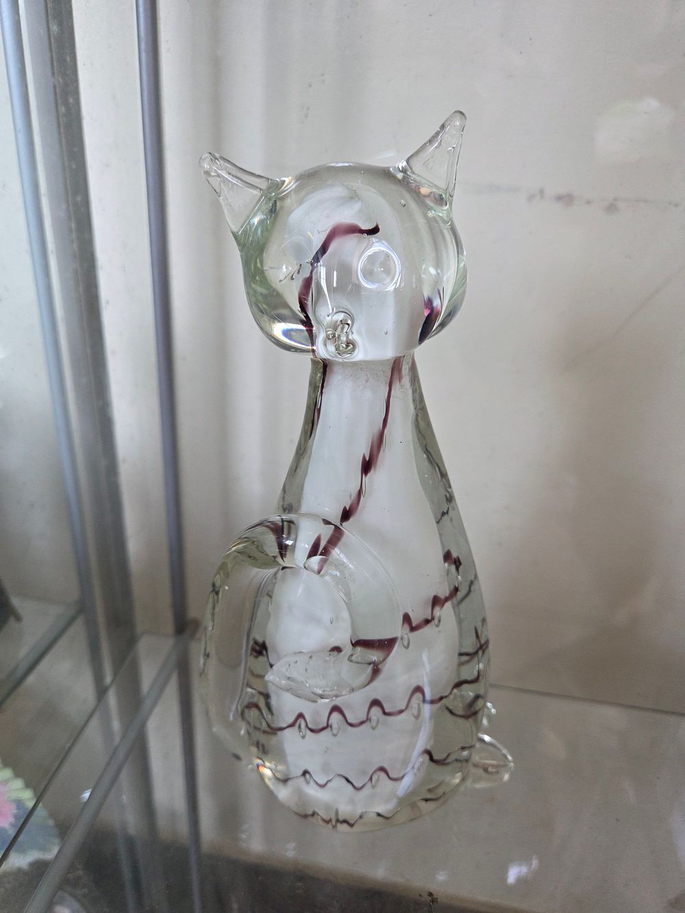 Lot 636 – Mid-century studio art glass cat figurine with internal trail and fish inclusion