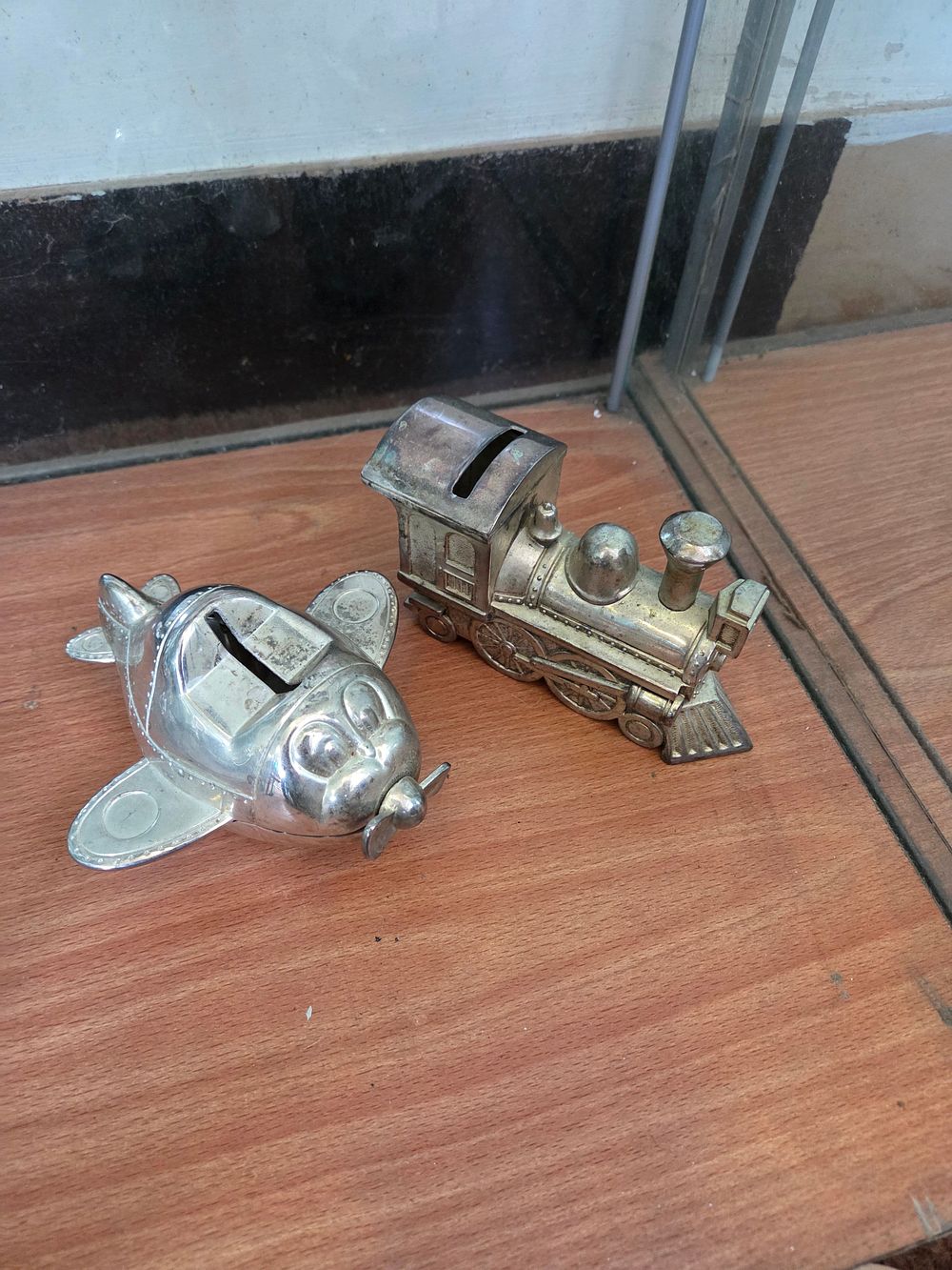 Lot 639 – A Pair of Silver-Plated Novelty Still Banks in the Form of a Locomotive and an Aeroplane