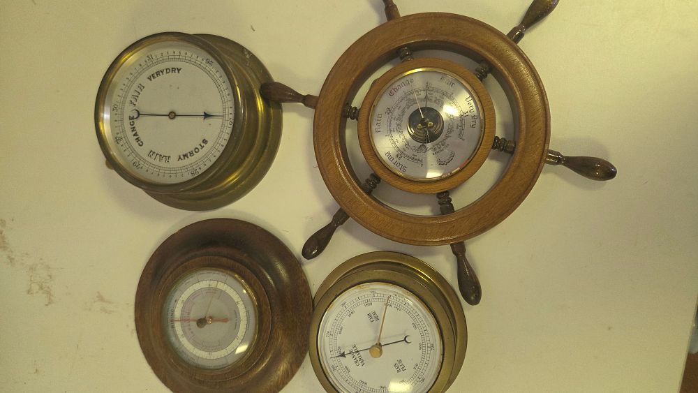 Lot 210 – A Collection of Four Brass and Wood Cased Aneroid Barometers