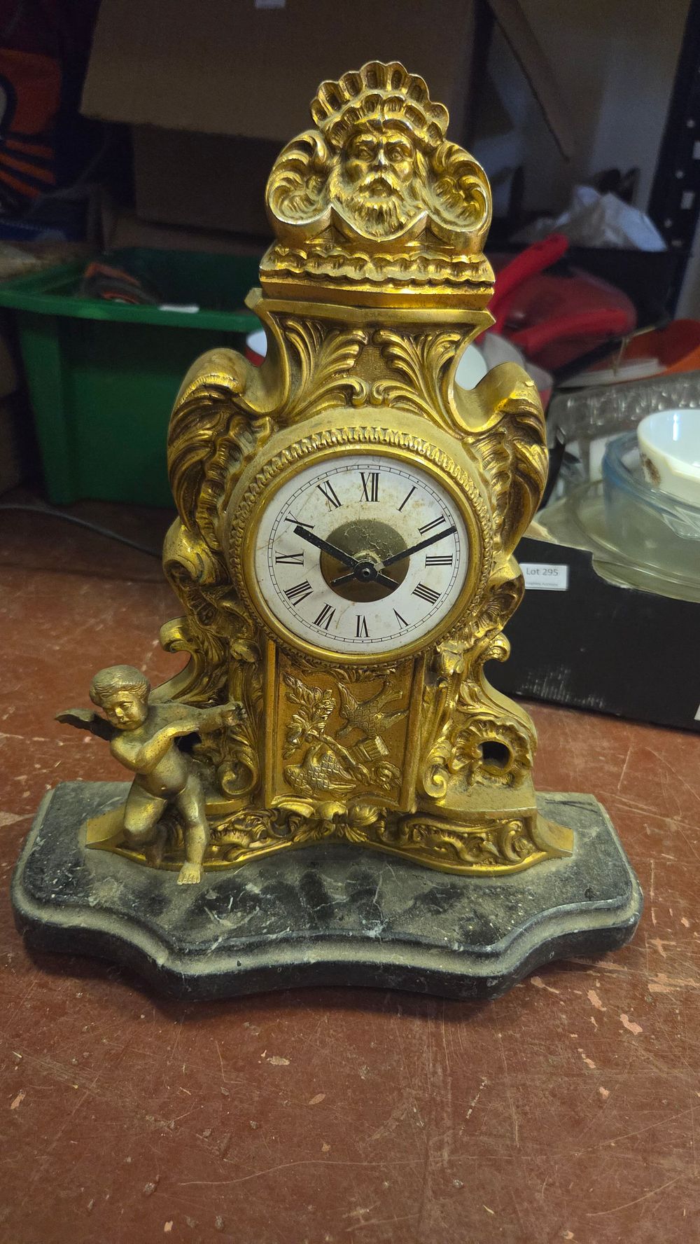 Lot 296 – A Rococo Style Gilt Metal and Marble Mantel Clock