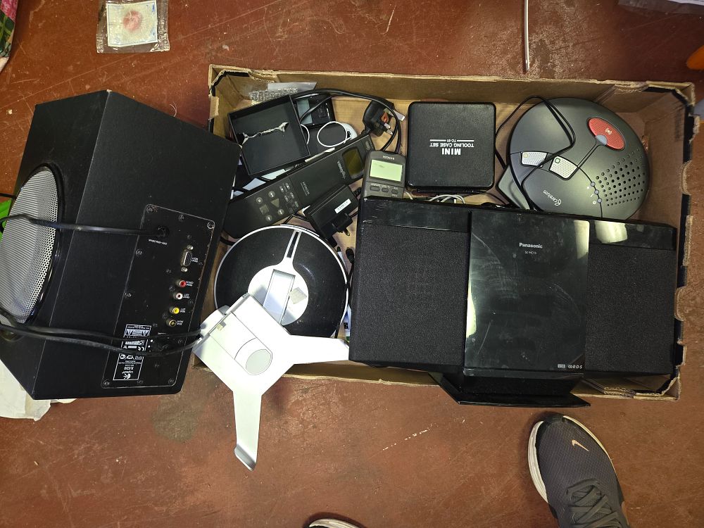 Lot 414 – An Assortment of Consumer Electronics and Accessories including Panasonic Stereo System, Logitech Subwoofer, and Careium Alarm Hub