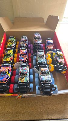 A Group of Eleven Fast Wheels Pop-Up Graffiti Monster Trucks in Trade Box