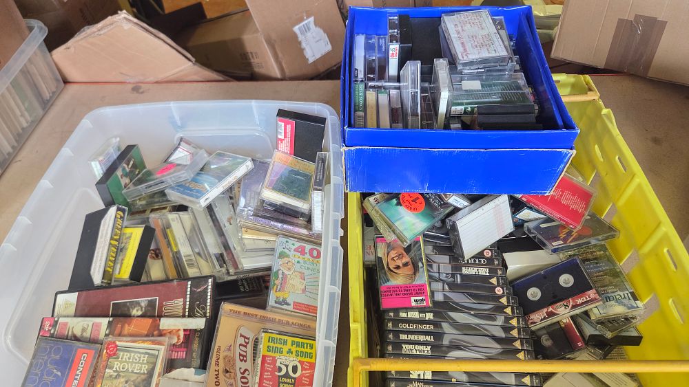 Lot 289 – Three Boxes of Home Media including James Bond VHS Tapes, Irish Music CDs, and Audio Cassettes