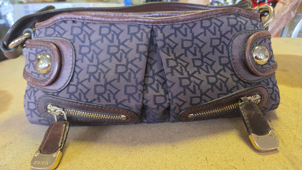 Lot 357 – A DKNY Monogram Canvas and Brown Leather Shoulder Bag and purse