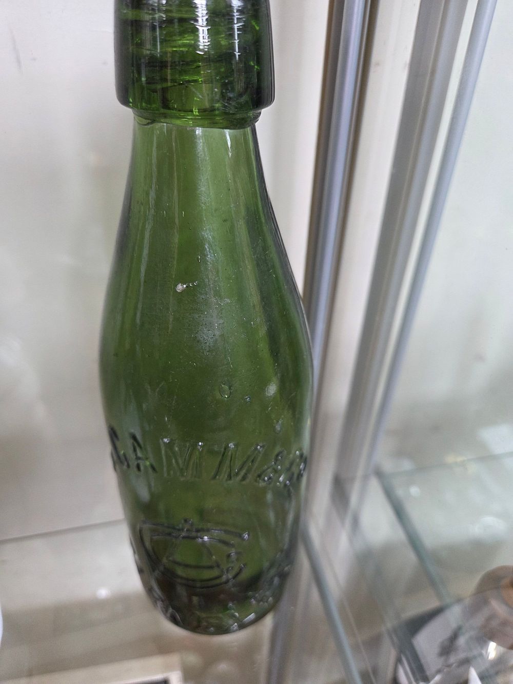 Lot 609 – A Victorian Dark Green Glass Hamilton or Torpedo-Shaped Soda Bottle for James Ward