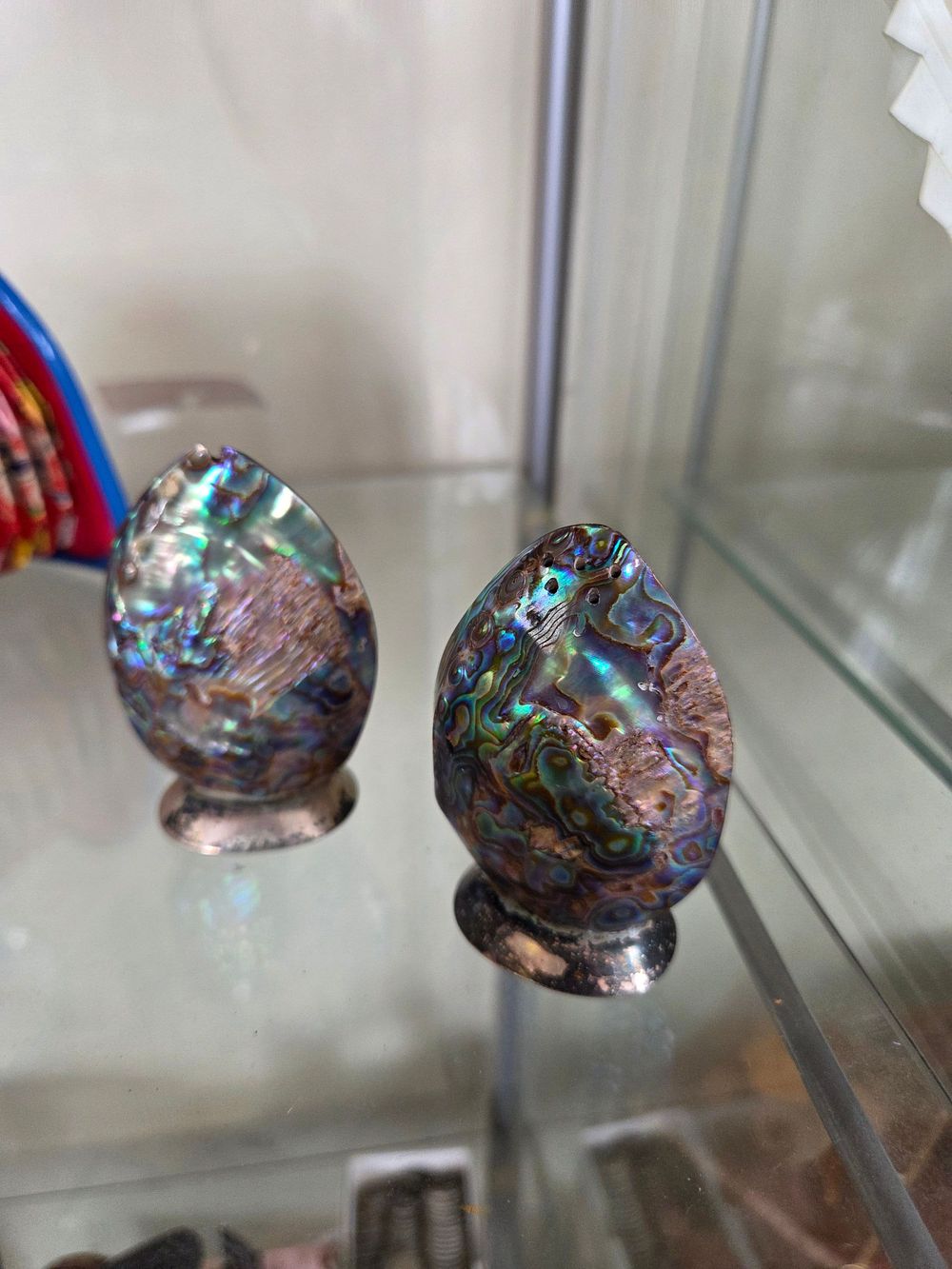 Lot 619 – A Pair of Abalone Shell and White Metal Salt and Pepper Shakers